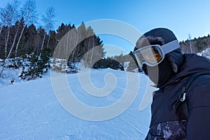 Skier next to the ski slopes at sunset on a sunny day in the high mountains, Grandvalira, Pyrenees, Andorra.