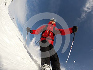 Skier performs a high speed turn on a ski slope.