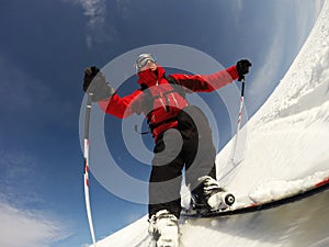 Skier performs a high speed turn on a ski slope.