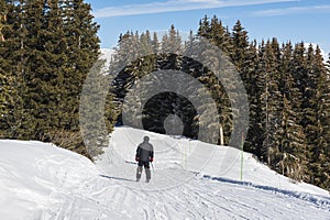 Skier on a piste in alpine ski resort