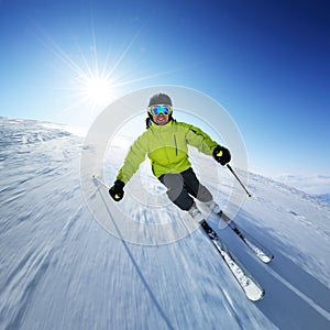 Skier on piste in high mountains photo