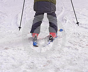Skier on piste in mountain snow