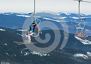 Skier on a platform on a background of high snow mountains