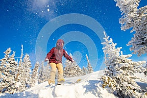 Skier is preparing for jump, lower angle of ski, blue sky winter forest