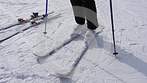 A Skier Puts On His Downhill Ski On White Ski Boots