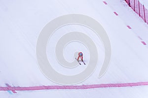 Skier racing down the Steep Speed skiing slope at Velocity Challenge and FIS Speed Ski World Cup Race at Sun Peaks Ski Resort