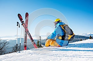 Skier resting on top of the mountain