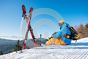 Skier resting on top of the mountain