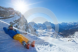 Skier resting in winter mountains