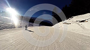 A skier rides down a difficult ski run on a sunny day in the French Alps,