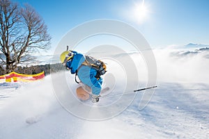 Skier riding in the mountains on a sunny winter day