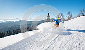 Skier riding in the mountains on a sunny winter day