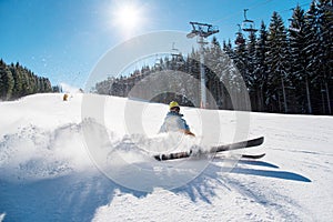 Skier riding in the mountains on a sunny winter day