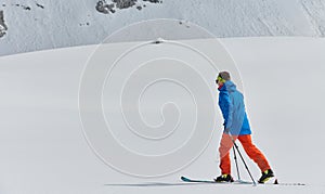 A Skier Scales a Treacherous Alpine Peak