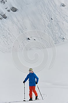 A Skier Scales a Treacherous Alpine Peak