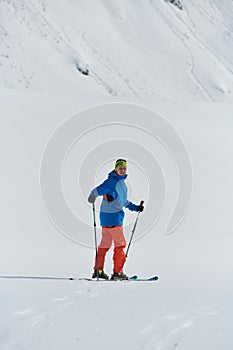 A Skier Scales a Treacherous Alpine Peak