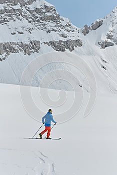 A Skier Scales a Treacherous Alpine Peak