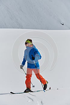 A Skier Scales a Treacherous Alpine Peak