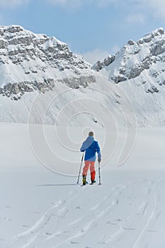 A Skier Scales a Treacherous Alpine Peak