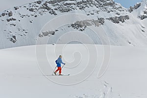 A Skier Scales a Treacherous Alpine Peak