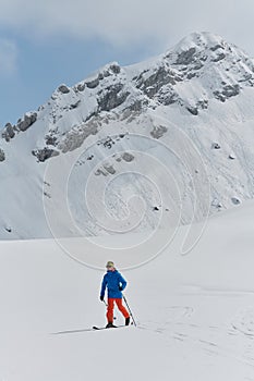 A Skier Scales a Treacherous Alpine Peak