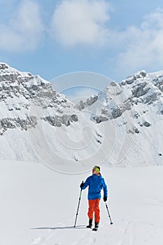 A Skier Scales a Treacherous Alpine Peak