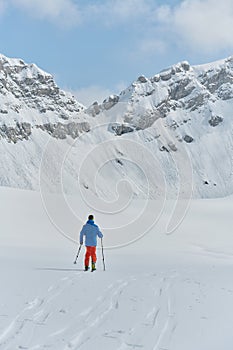 A Skier Scales a Treacherous Alpine Peak