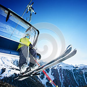 Skier siting on ski-lift - lift in mountains