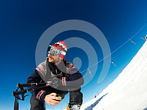 Skier sitting waiting to start skiing