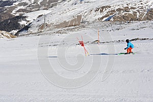 Skier skiing dowhill race on the piste in the mountains. Alps in winter.