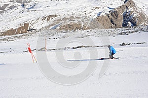 Skier skiing dowhill race on the piste in the mountains. Alps in winter.