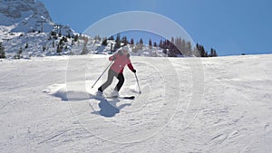 Skier skiing down carving on the slope in the mountains in winter