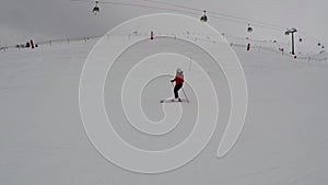 Skier Skiing Down The Ski Slope On Alpine Ski In The Background Of Funicular