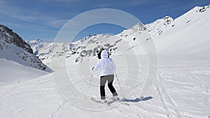 Skier Skiing Down Slalom On Snowy Hillside In Mountains In Winter On Ski Resort