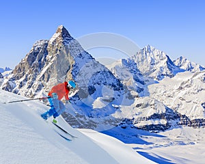 Skier skiing downhill.