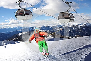 Skier skiing downhill in high mountains