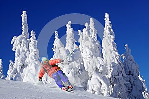 Skier skiing downhill in high mountains