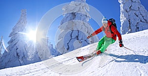 Skier skiing downhill in high mountains