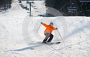 Skier skiing downhill in the moment of falling