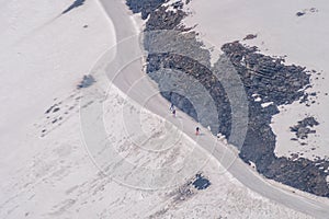 Skier skiing with helmet alone on the ski slope towards Matterhorn mountain on a beautiful sunny day in Switzerland