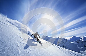 Skier Skiing On Mountain Slope photo