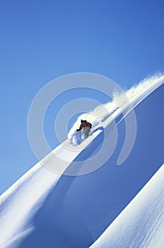 Skier Skiing On Steep Slope