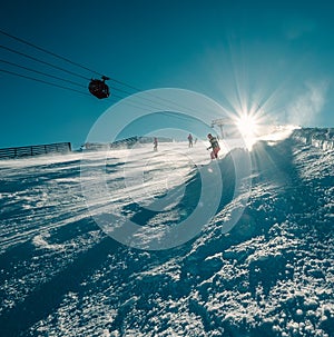 Skier slides down on the snow slope