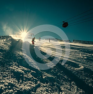 Skier slides down on the snow slope