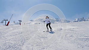 Skier Slides Down Snowy Slope In Mountains In Winter On Ski In Movement