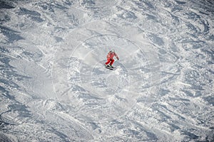 a skier sliding down a snow-covered slope alone