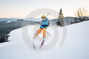 Skier in snow powder produces braking on slope of mountain