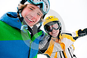 Skier and snowboarder in the snow