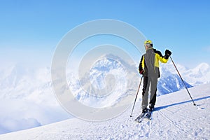 Skier standing on mountain slope