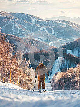 A skier stands poised at the edge of a pristine ski run, gazing down at the winding trails against a backdrop of snow